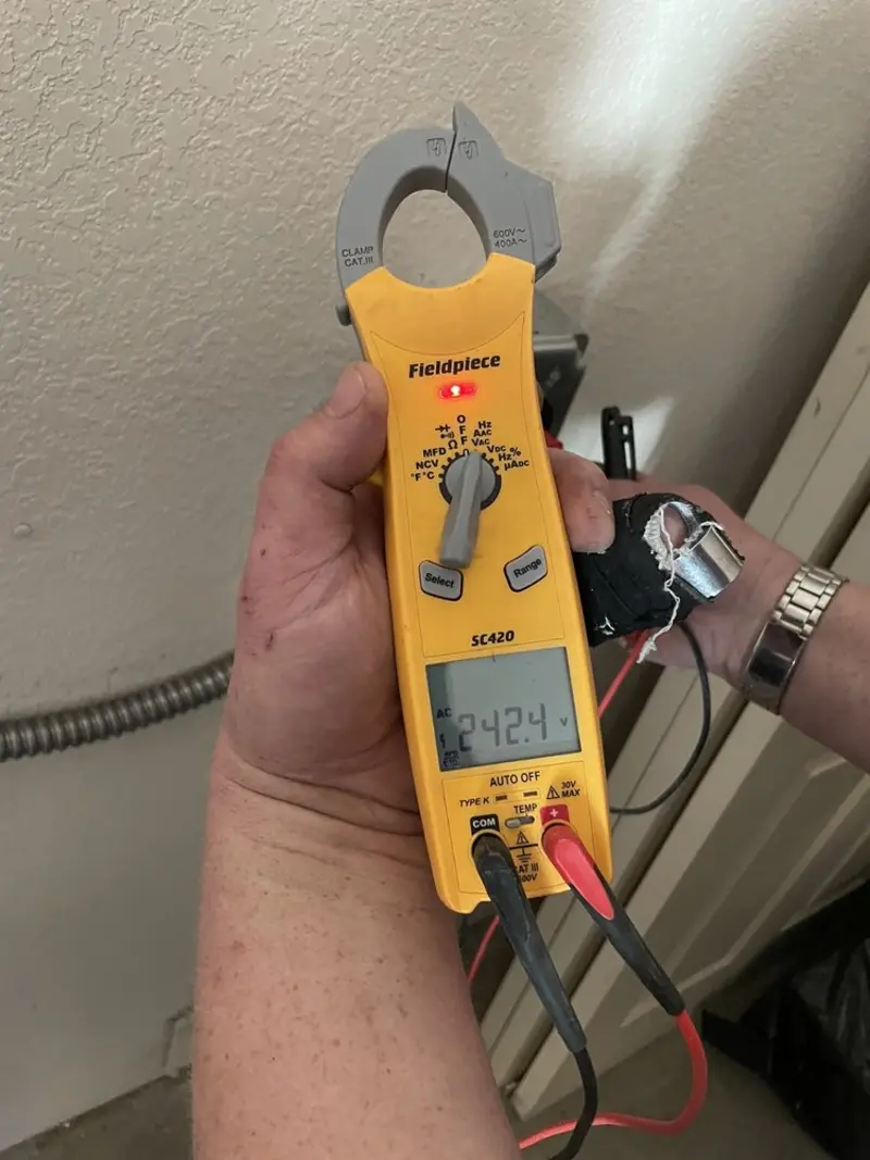 Voltage testing with clamp meter during Whole House Surge Protector in Celina